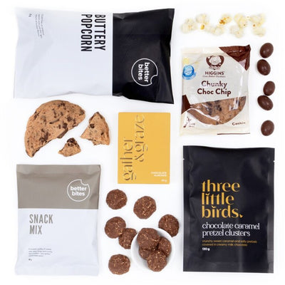 The Signature Snacks Gift Box is packed with easy-to-love bites: buttery popcorn, a chunky chocolate chip cookie, chocolate almonds, and caramel pretzel clusters.