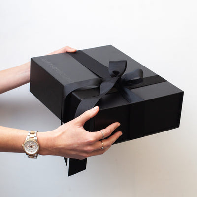 Luxe packaging with a magnet close black box and black ribbon